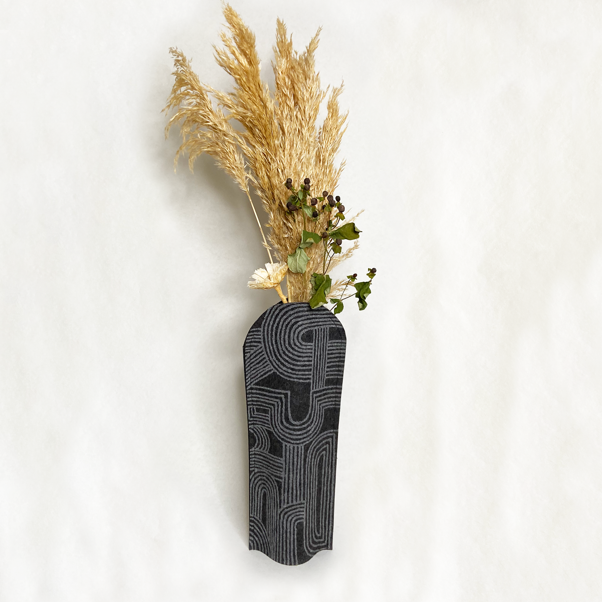Felt vase sleeve. Handmade, eco-friendly, and sustainable decor. Upcycle recycling through a flexible designed vase cover. 